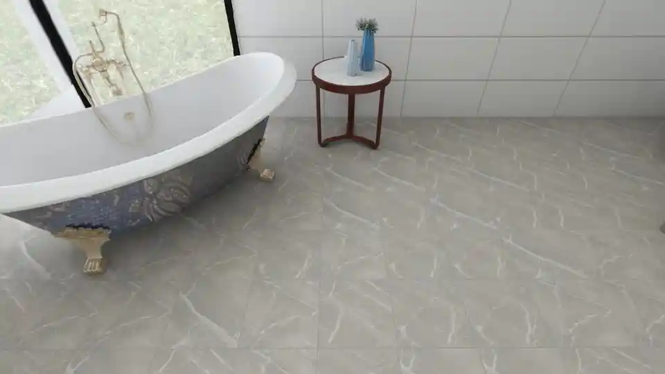 Grey tiles, a standing alone bathtub and a small table on the side