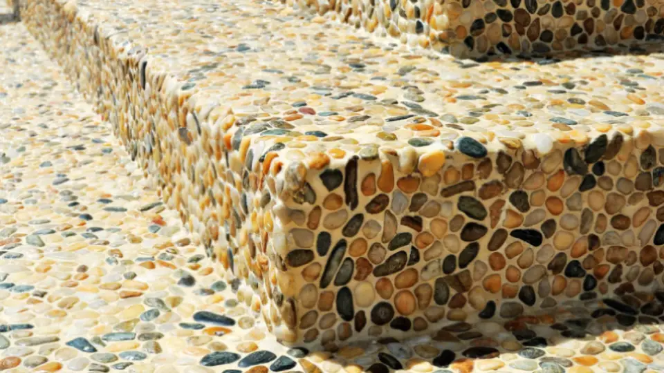 Stone tiles in pebble design with grey, beige, blue, orange and black colours