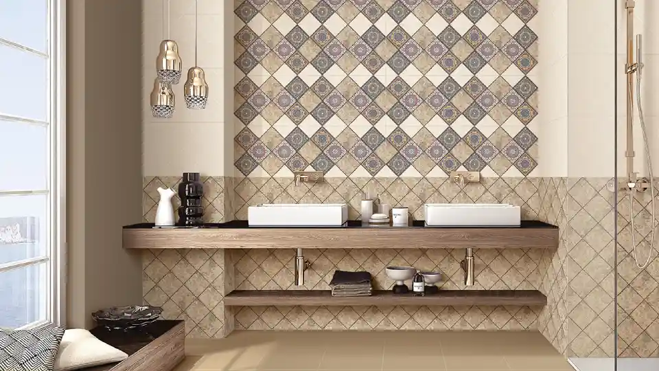 beige wall and floor tiles, 2 white wash basins on a handing wooden platform, other decorative pieces on the platform and 3 hanging lights
