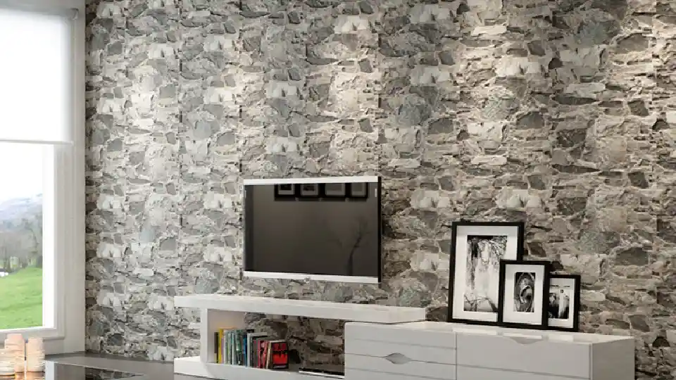 living room space with rock tiles feature wall with irregular pattern, TV unit, books, black & 3 white photo frames