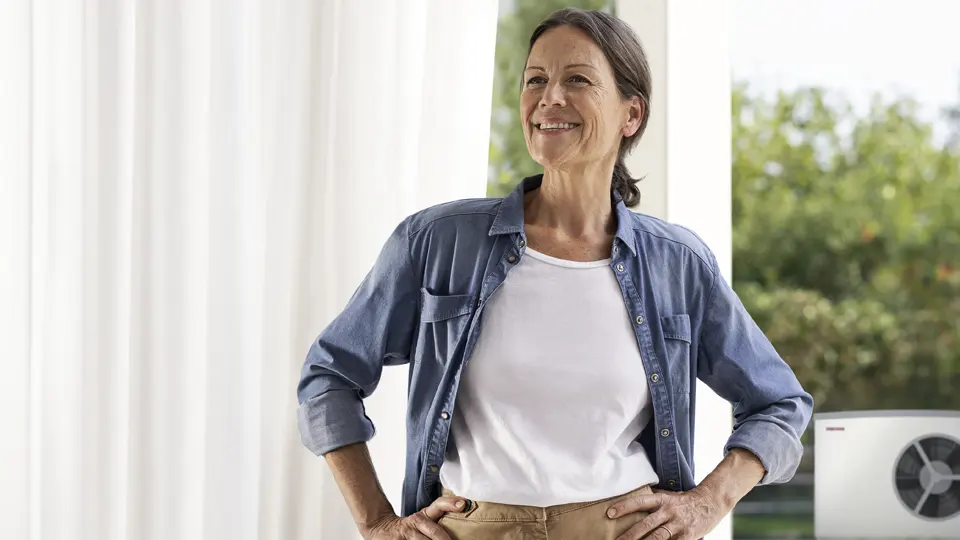 a woman infront of heat pump