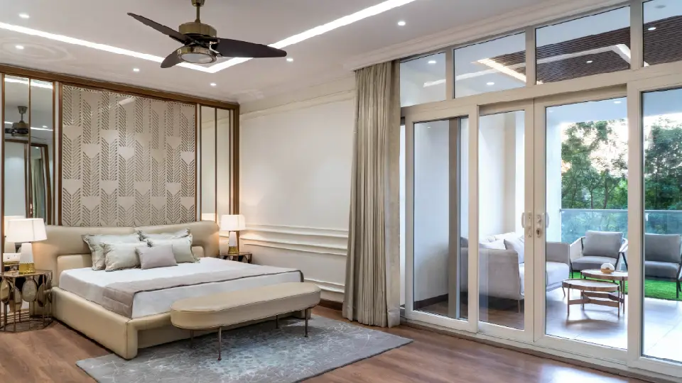 white bedroom with ceiling lights, bed, side tables, lamps and rug