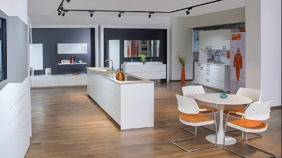 wooden floors in a kitchen with dining table, kitchen island, and ceiling lights