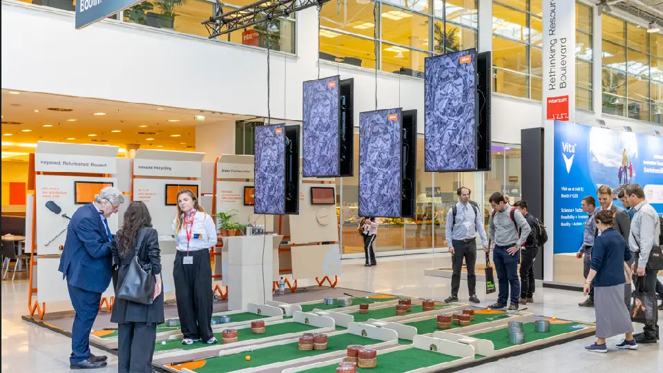 exhibition hall with crowd interacting with displayed products