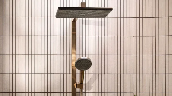 Gold-toned Hansgrohe Raindance Alive shower with square overhead rain shower and round handheld shower, mounted on tiled bathroom wall.