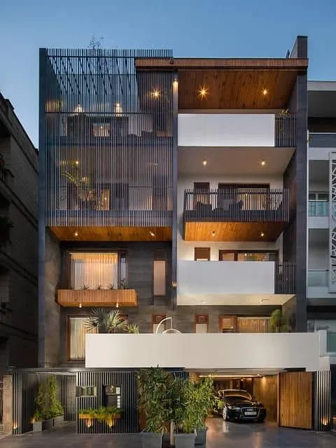 front elevation for multilevel building with jali design, tiles, and proper lighting