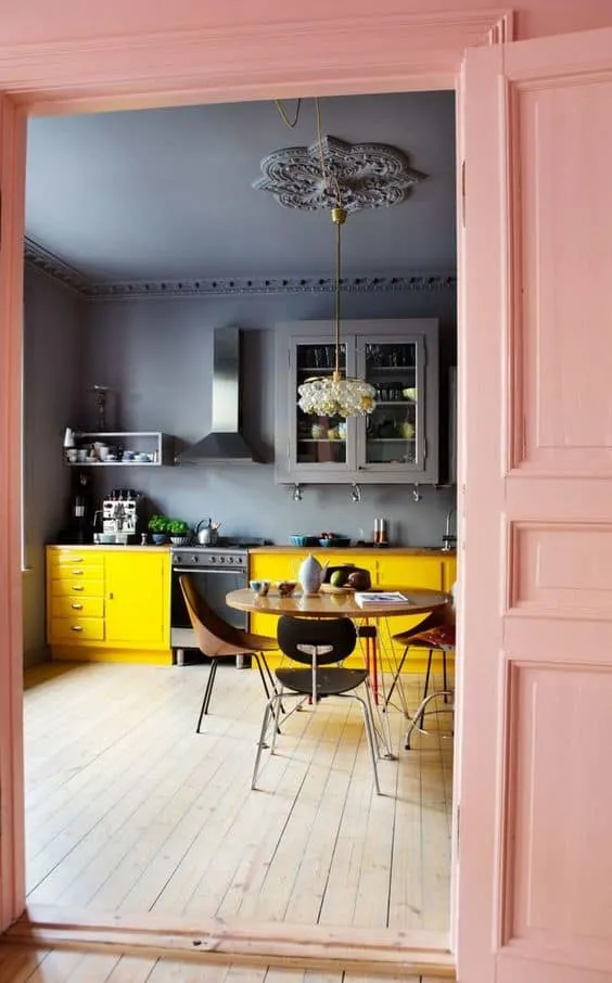 blue kitchen ceiling with walls and yellow cabinets with pastel peach doors