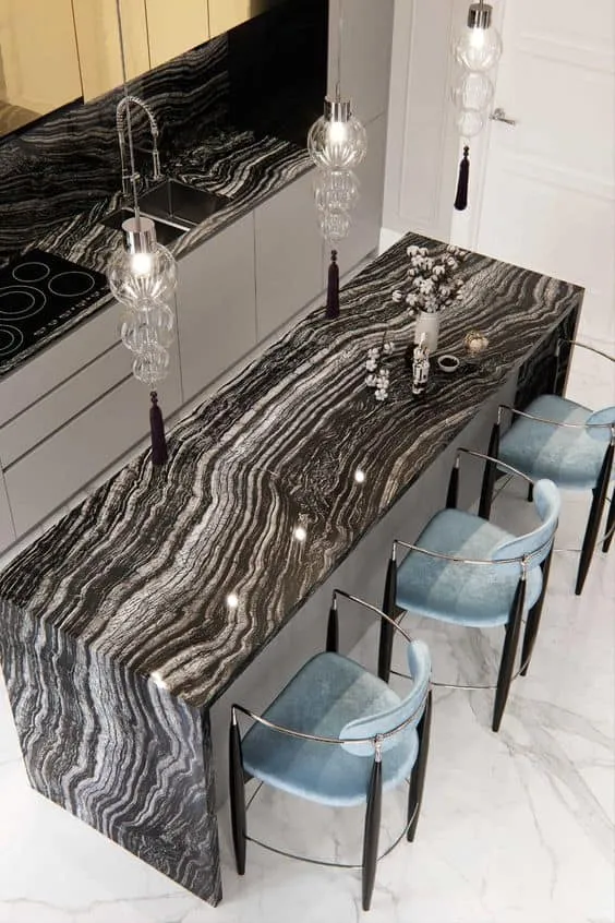 white waves on a black granite surface with white floors 