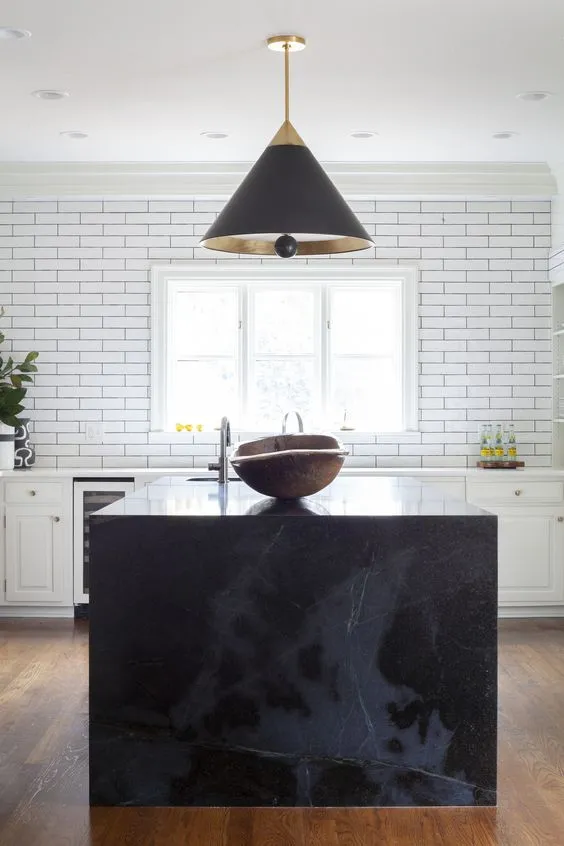 pure black countertop for kitchen with an overhead black light and white interiors