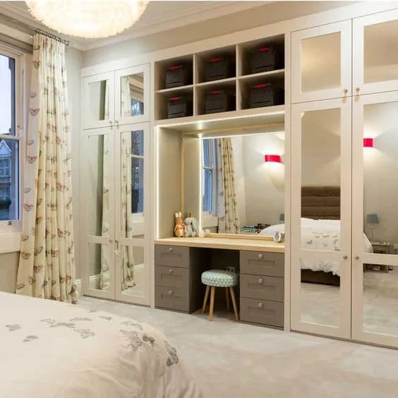 white mirror wardrobe with dressing table and top and bottom shelves