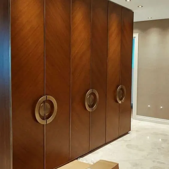 round designer closet handles for a brown closet