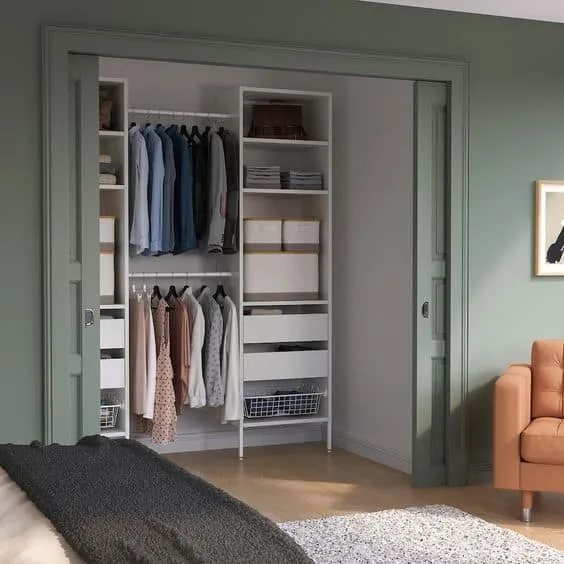 white and green walk-in closet with interior design, lights, and drawer system
