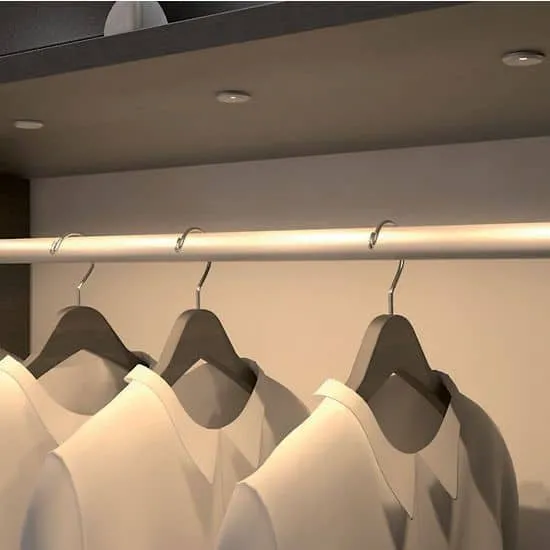 Recessed puck light for closet with rails and hangers