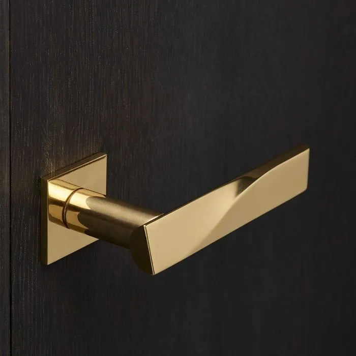 golden lever handle lock on square rose