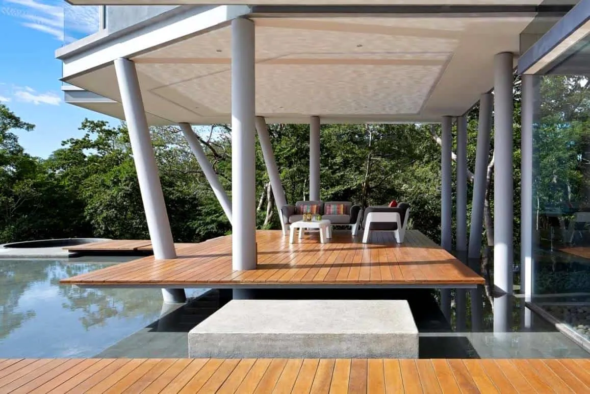 outdoor seating area with overhead panel and pool view