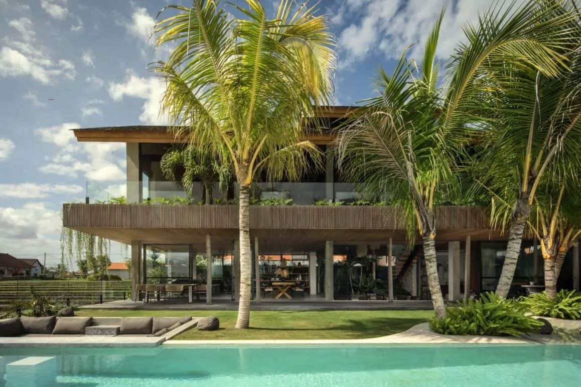 house design exterior with a swimming pool and tall palm trees