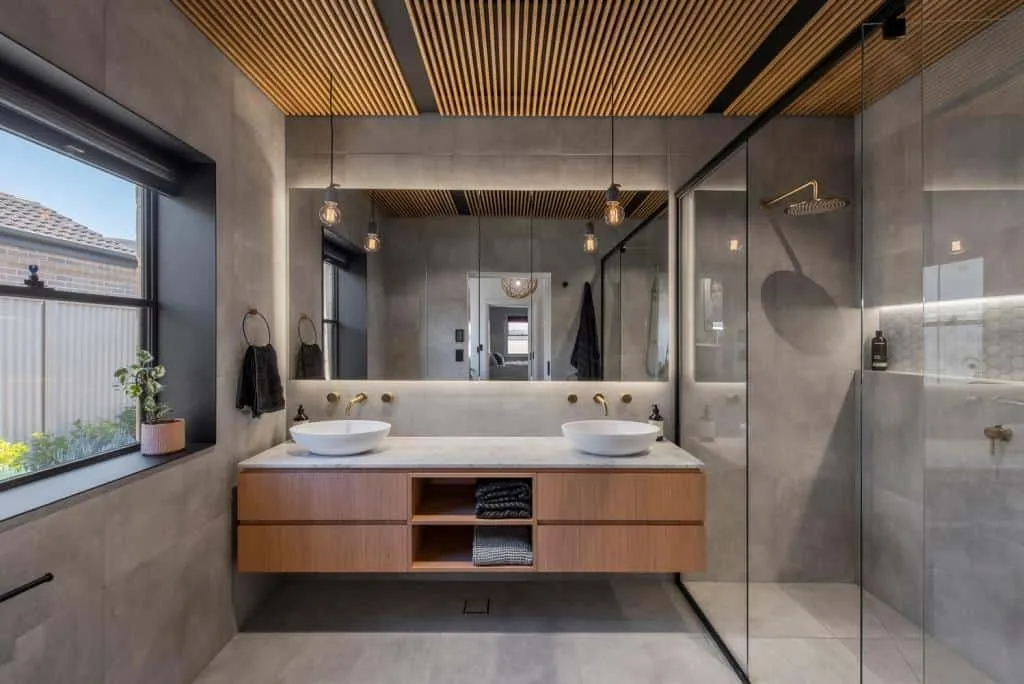 bathroom with grey wall and floor tiles