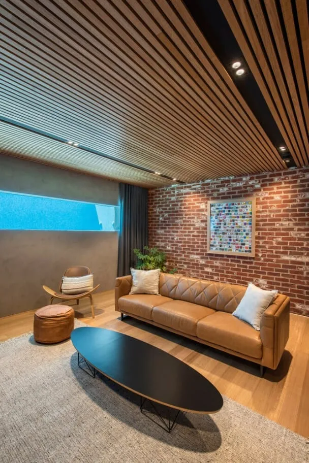 home designs interior having a faux brick wall and wooden plank ceiling