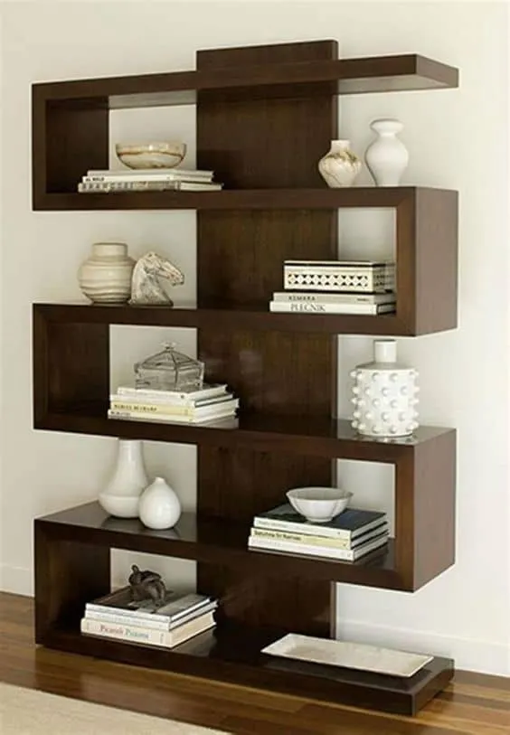 brown wooden bookcase, books and showpieces arranged, zigzag pattern