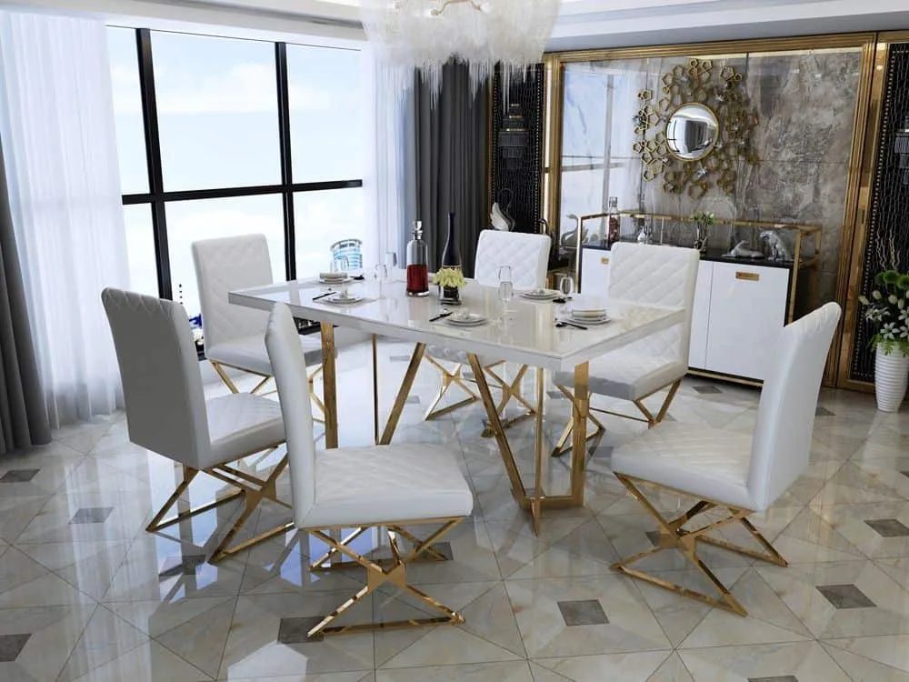 A dining room with a white center-table, wall decorations and a house plant