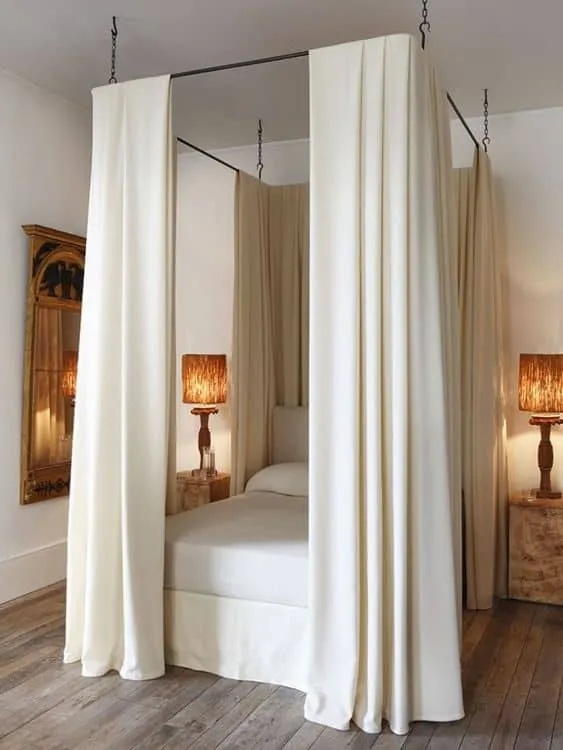 White curtains set around Bed