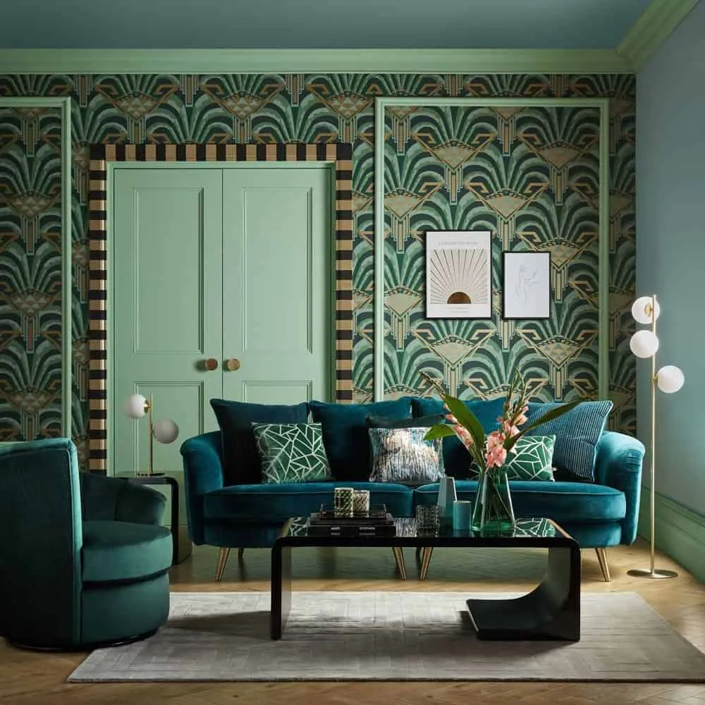 Green room with stunning wall design and emerald green sofa