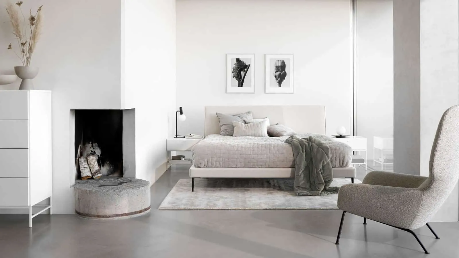 bedroom with white walls, white pillows and mattress, beautiful double bed design, chair, grey floor, wall hangings