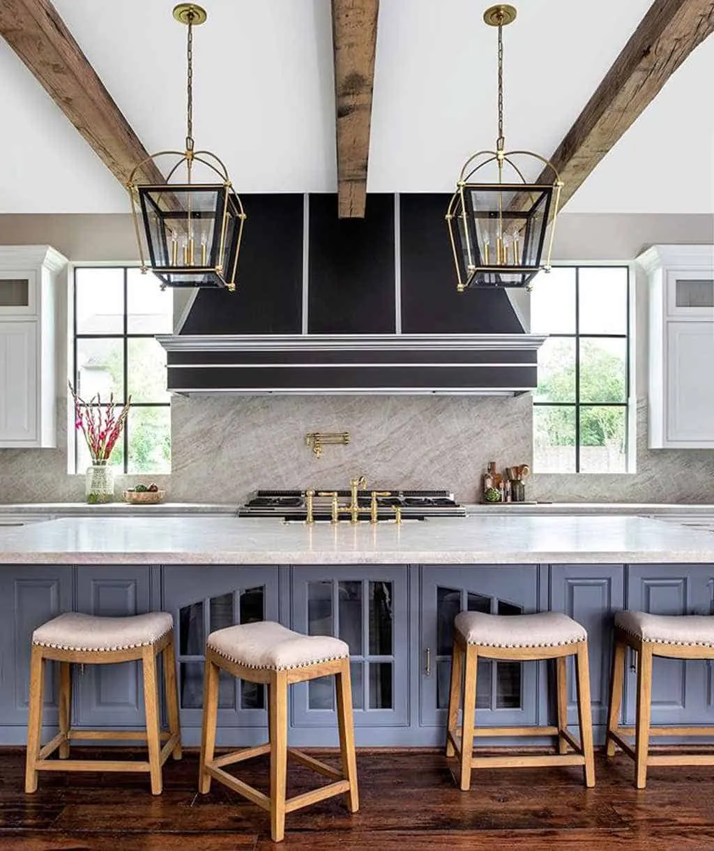metallic light fixtures in a kitchen with wooden seats and white counters