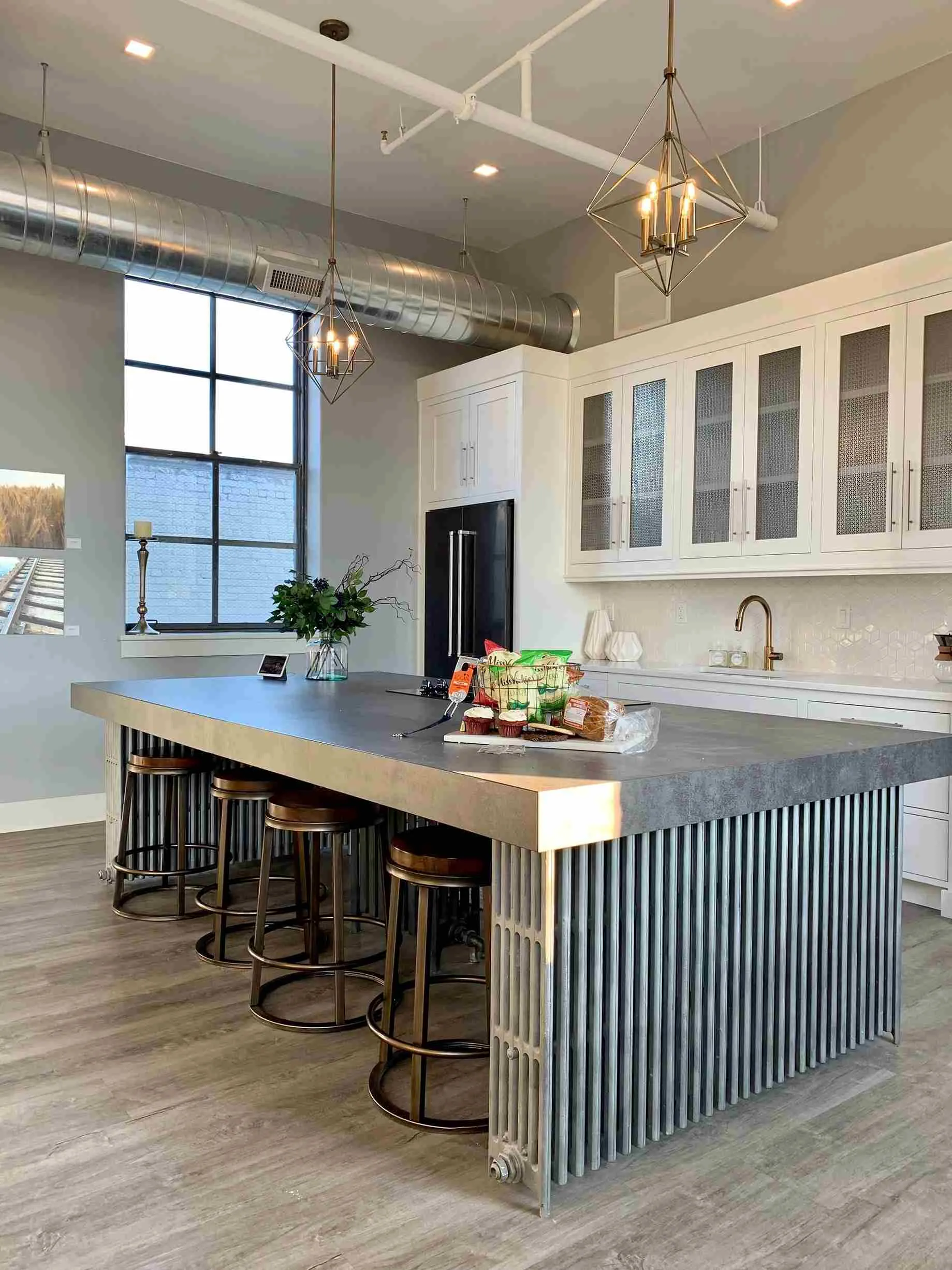 pendant ceiling lights in a kitchen with brown wooden floors and a dining table