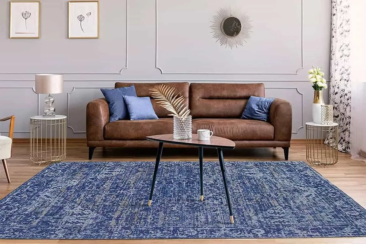 Modern small living room decoration interior design with blue colour rug, simple accent walls and brown leather couch