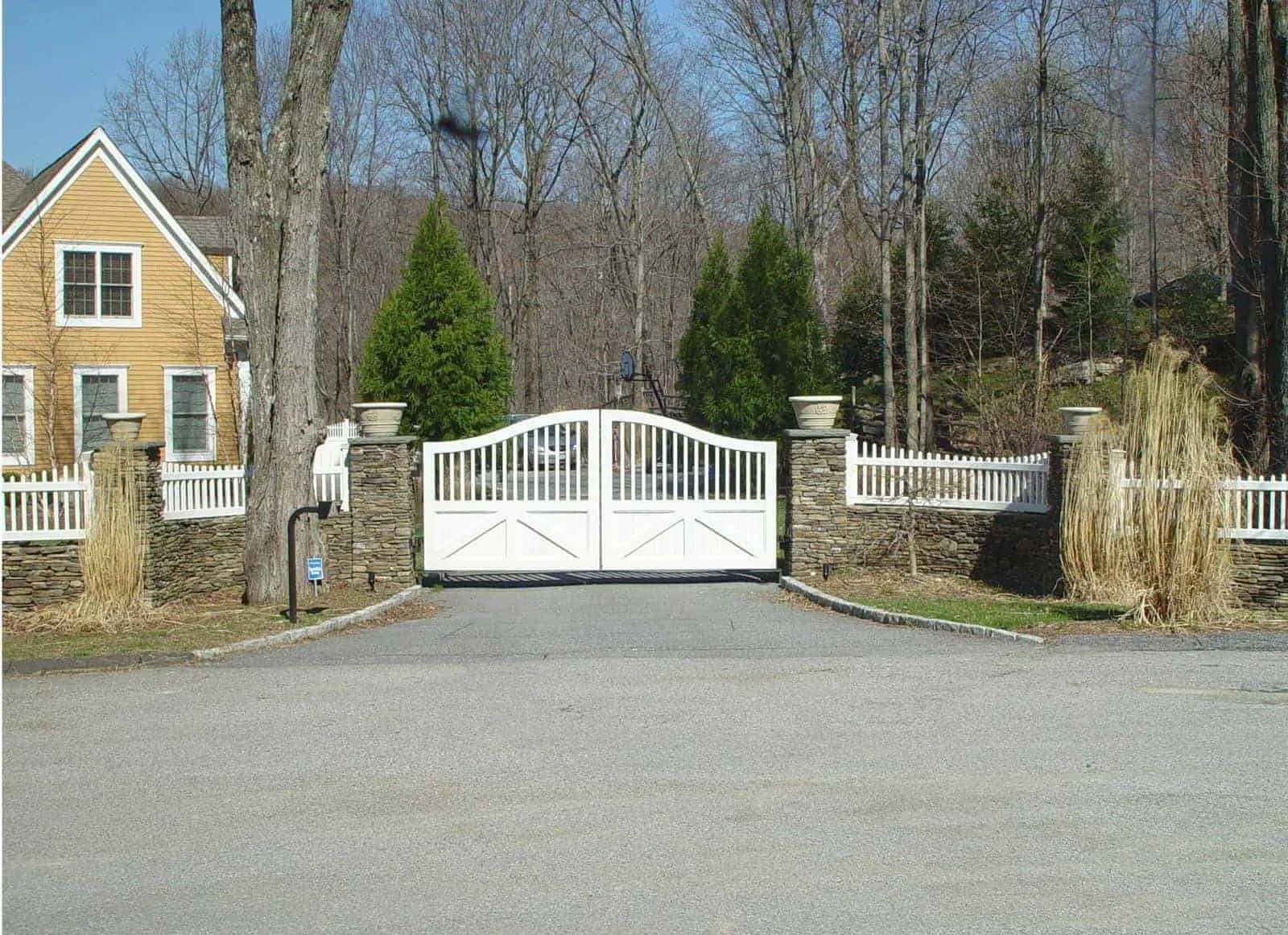 latest steel and iron main gate design for a country home with white fences