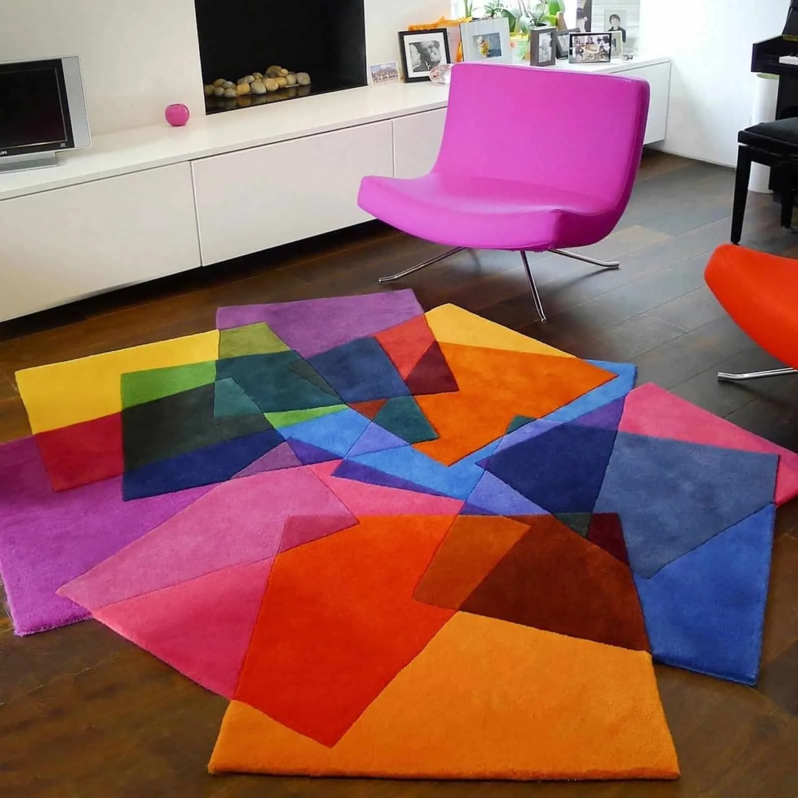 stunning multicolored carpet with red, purple and blue in a living room with pink chair