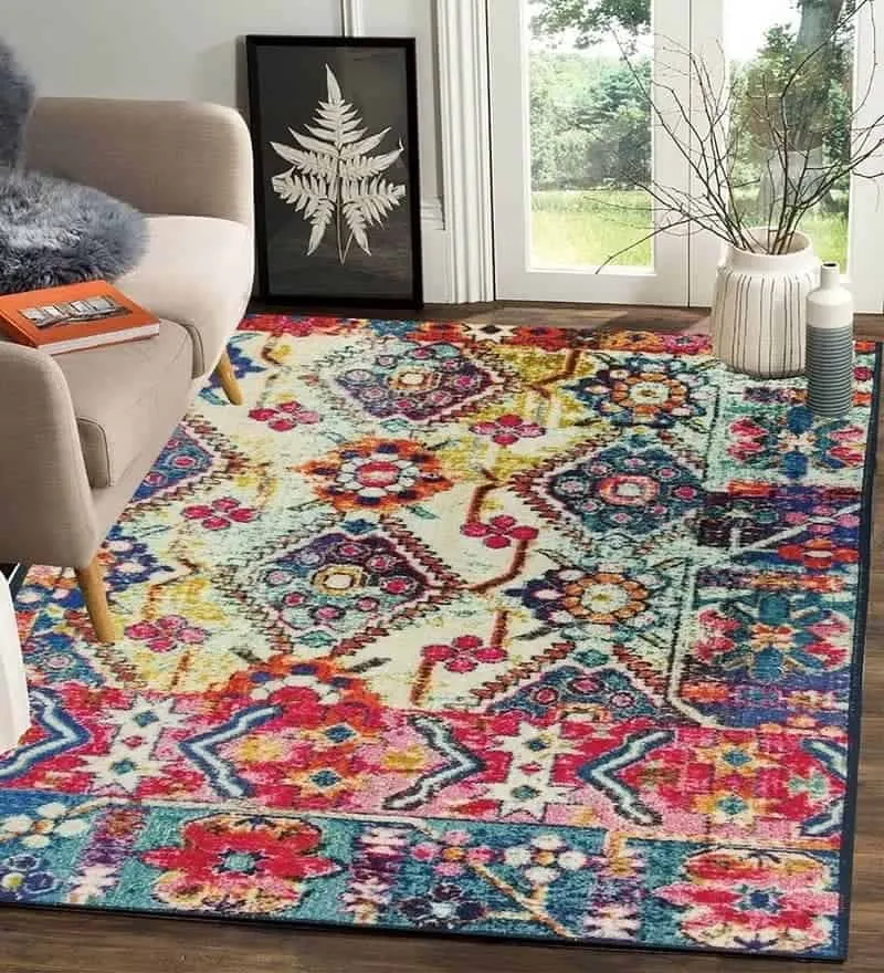 multicolor rug with pops of red, a sofa and an outside view