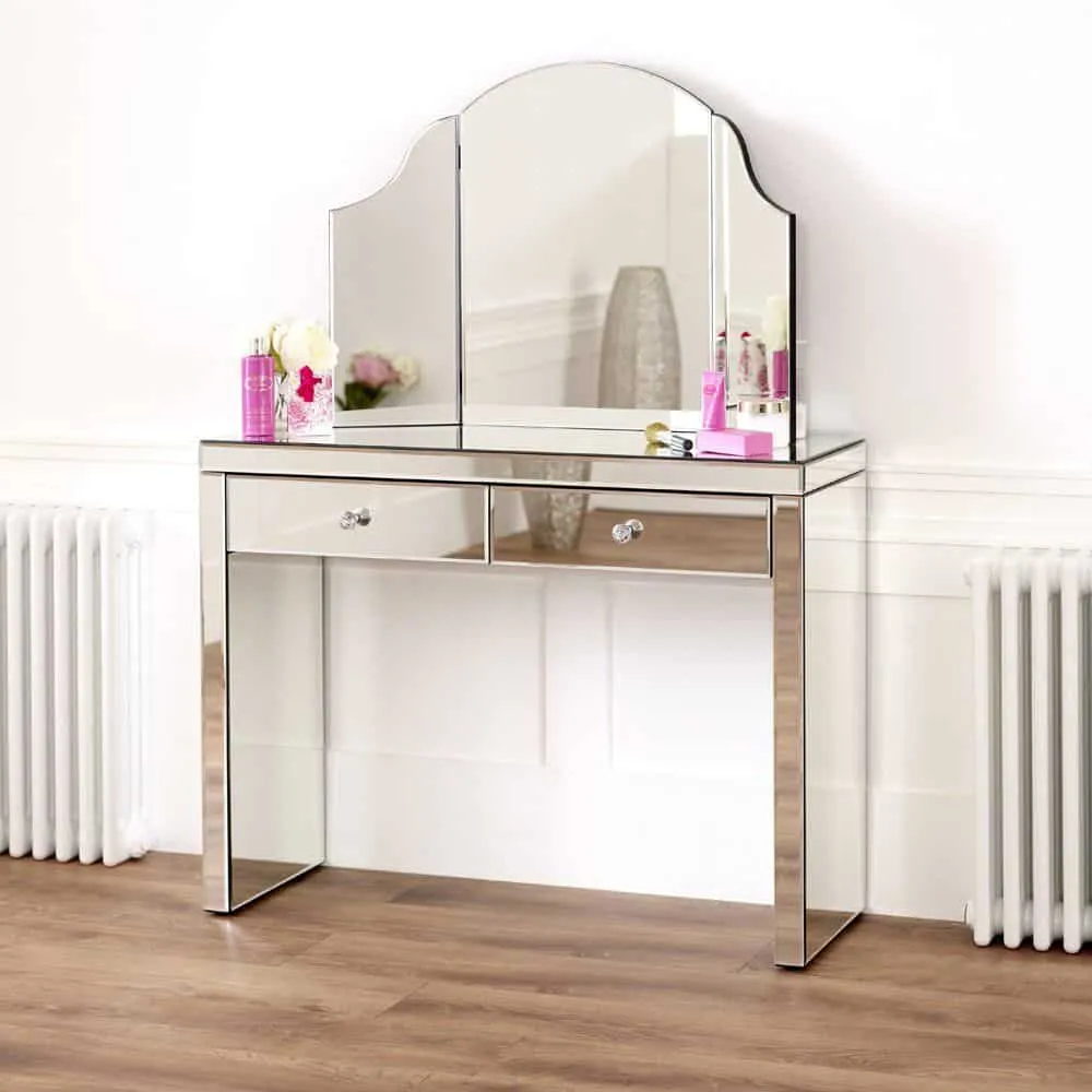 A classy glass dressing table design with 3-fold mirrors and minimum storage space, in a white room.