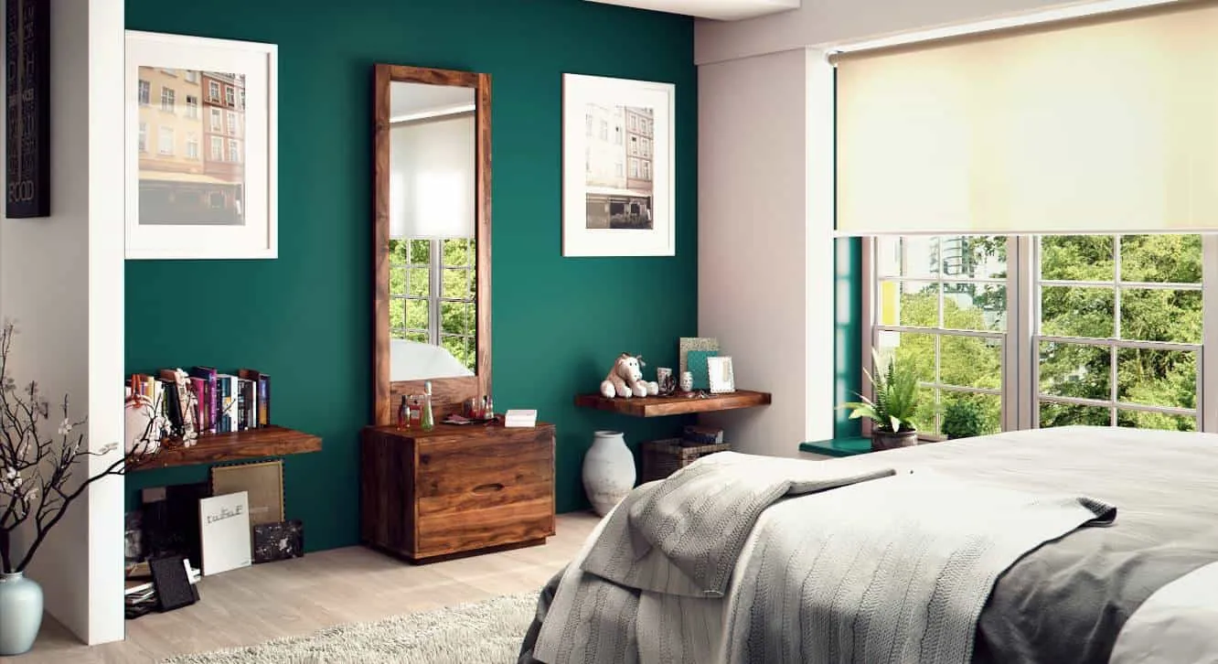 An exquisite wooden dressing table design with a rectangular mirror and minimum storage space, in a well-furnished green bedroom.