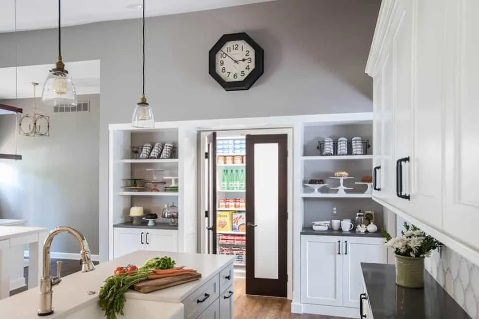A nice kitchen pantry in a kitchen area with best furniture and wall tiles.