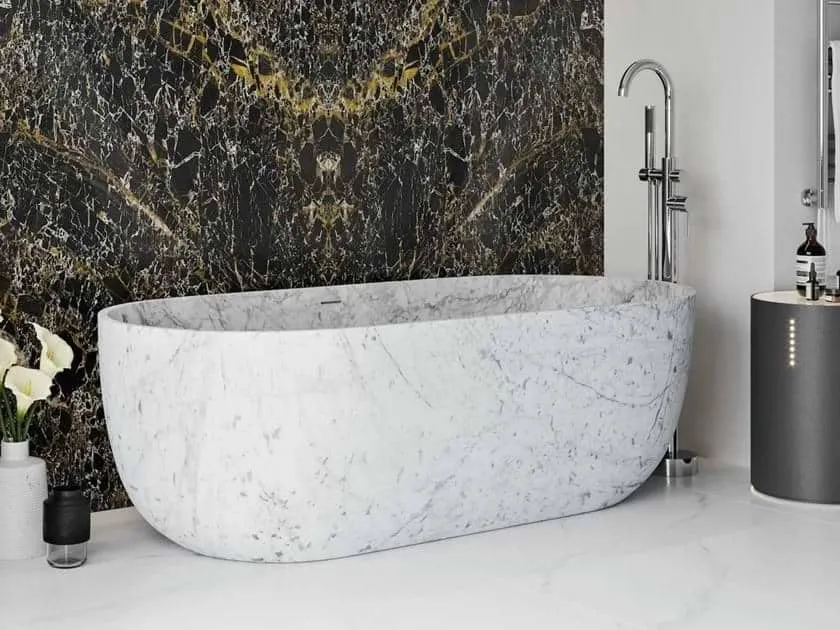 White marble free standing bathtub with black marble wall