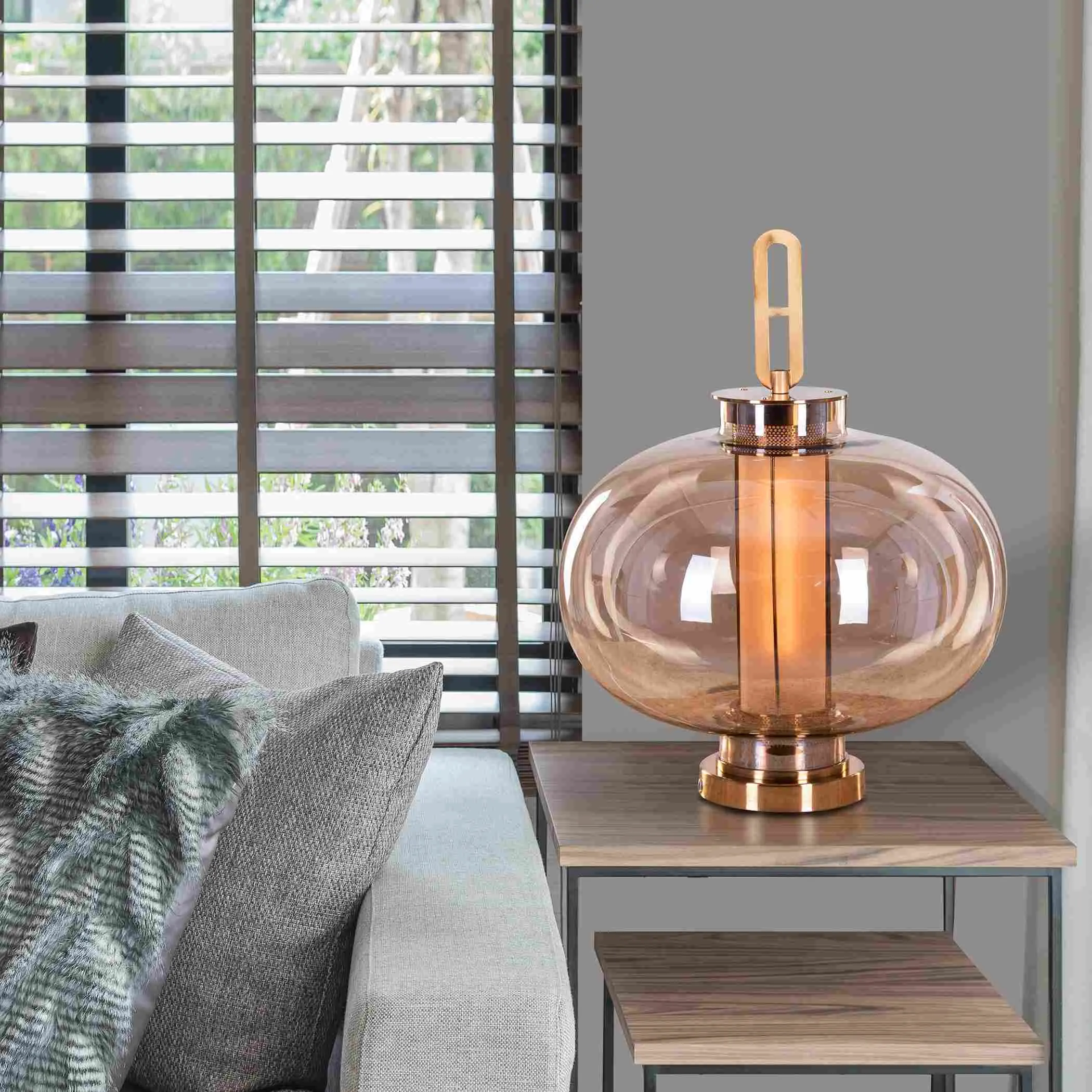 table lamp indoors with a sofa, table and window