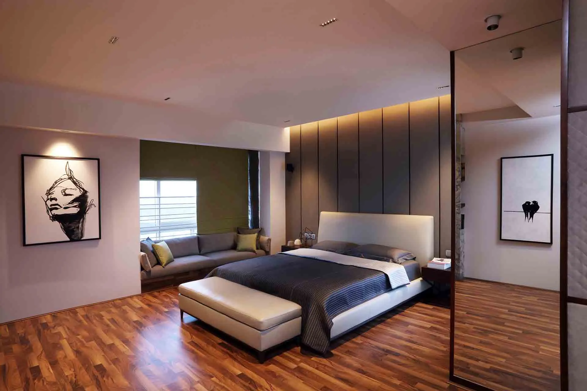 brown wooden floors in a bedroom with bed, painting, mirror