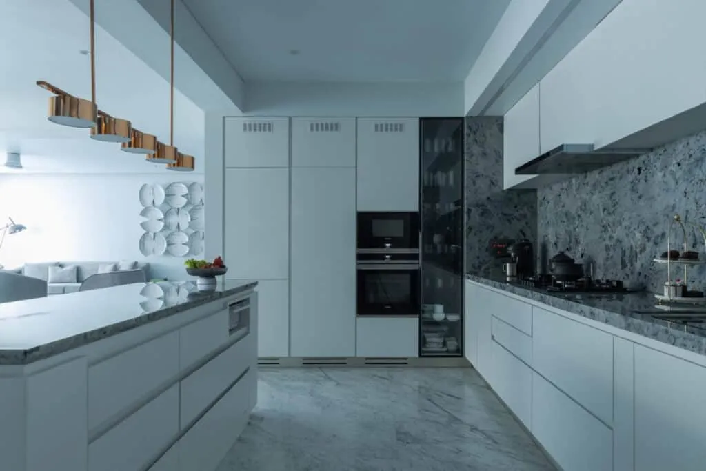 white kitchen with cabinets hanging lights