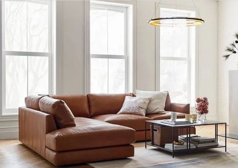 modern leather sofa set design in brown colour in well-lit room with wood flooring