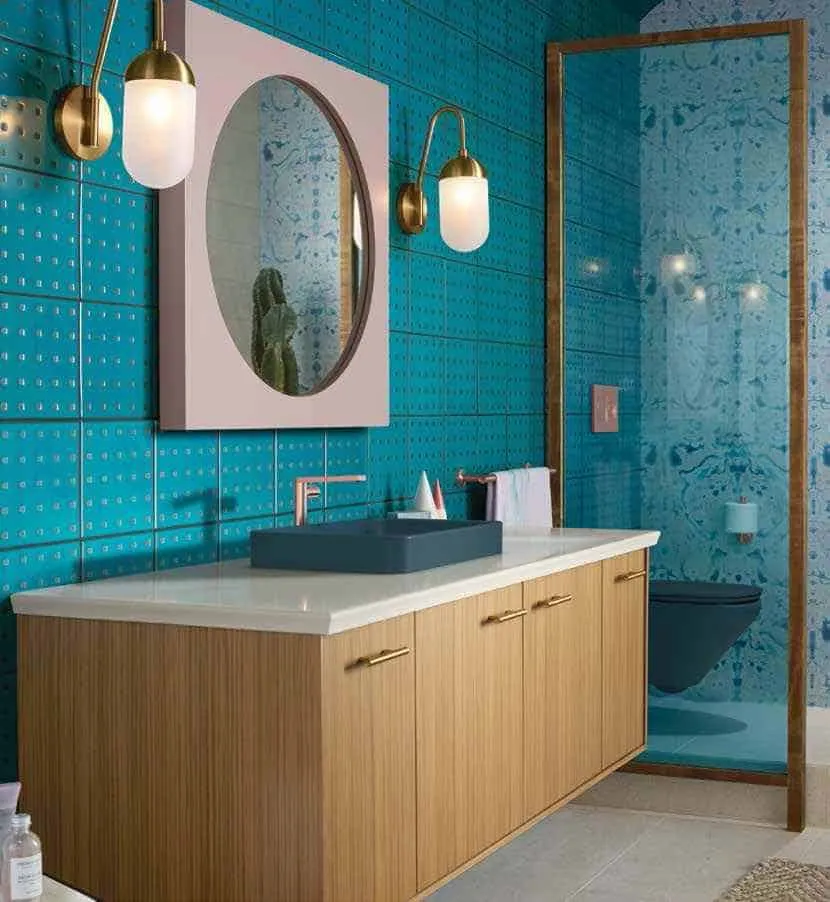 modern bathroom by top brand kohler, aqua coloured bathroom with soft pink mirror, peacock green washbasin, and wooden vanity