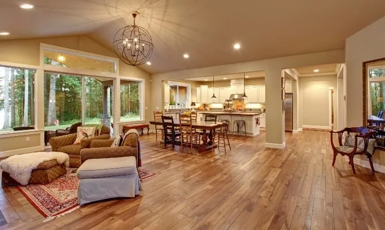 wooden flooring use in the house with couch, dining area and open kitchen