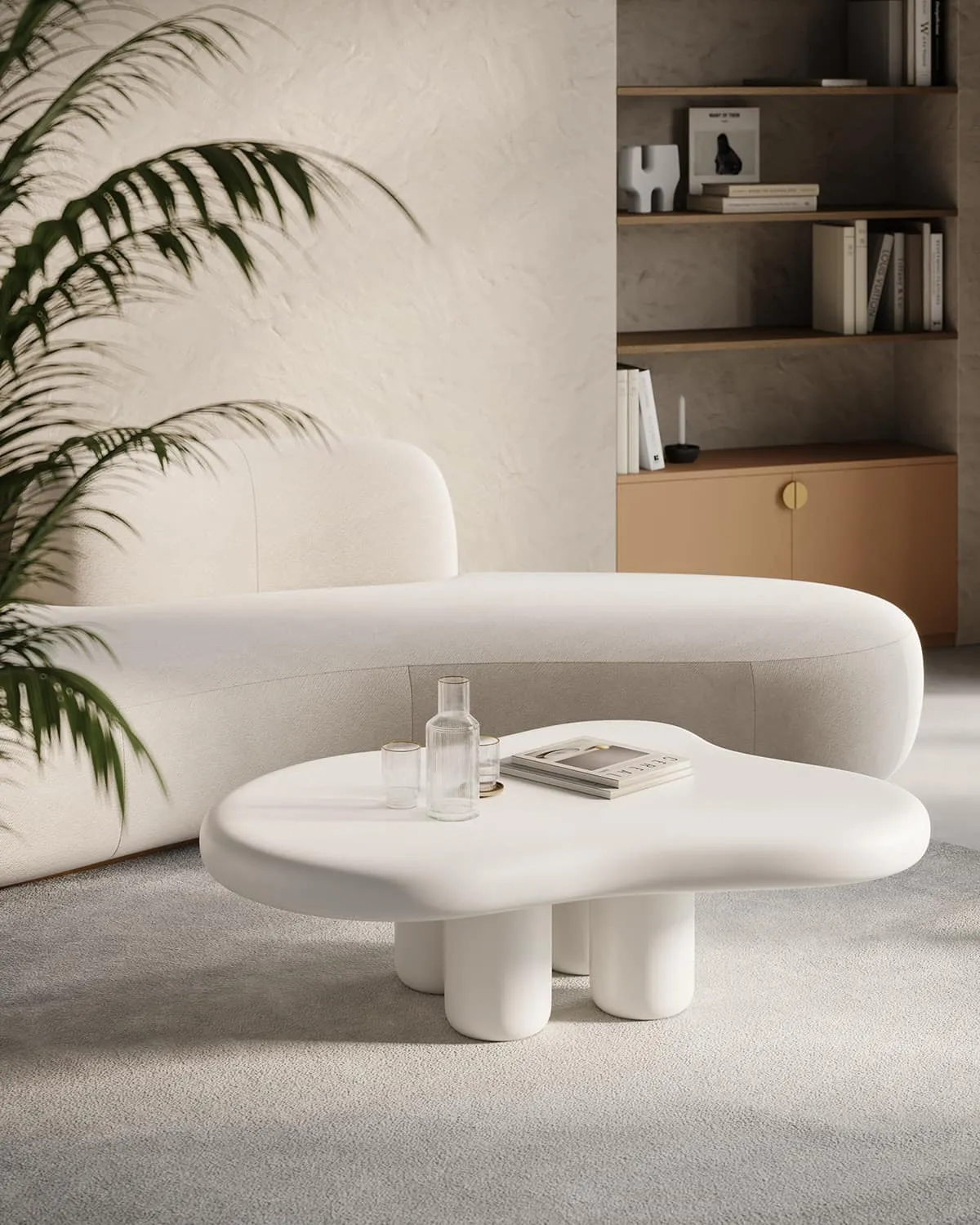 all white and stone free-form centre piece in a living room, with white marble floor, white sofa, white walls, wooden bookshelf, books, plant beside the sofa