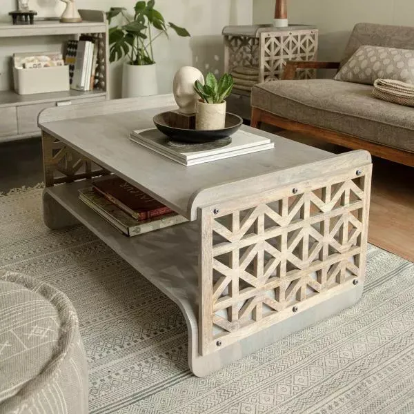 palace window decorative centrepiece, wooden coffee table, grey carpet, sofa, artificial plant on the table top, wooden book shelf