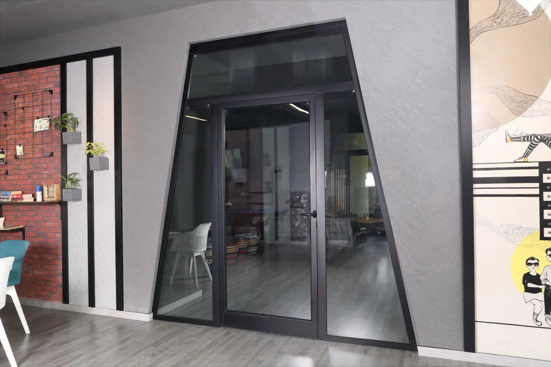 a trapezium shaped fenestration system made of glass and Duranium® by hindalco