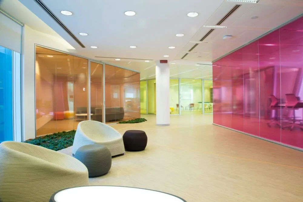 Different types of toughened or tempered glass in orange, pink and yellow in an office