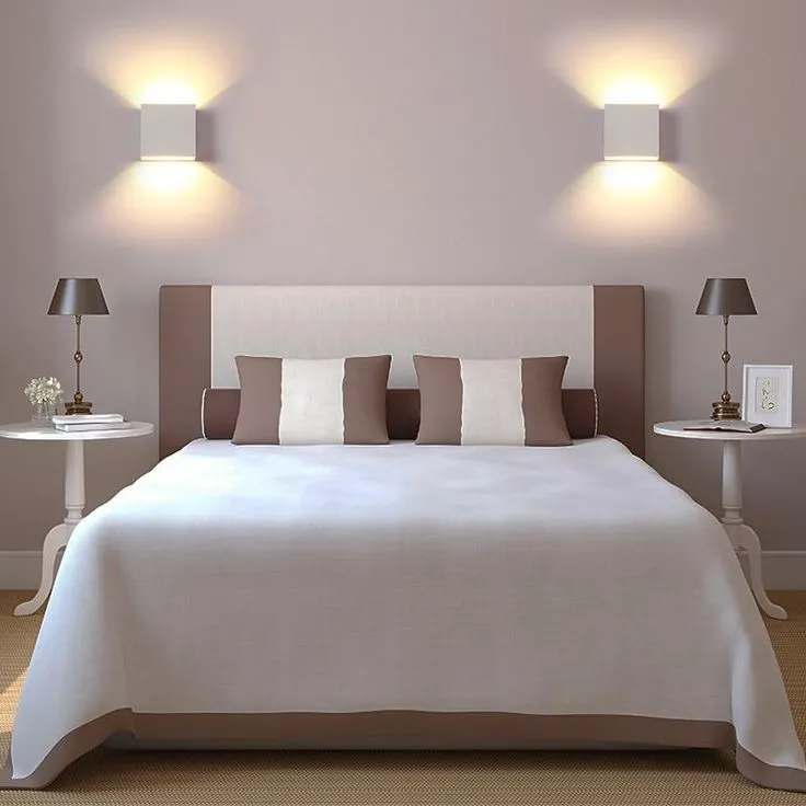 wall lights, with classic touch, white walls, side tables with side lamps, brown and white cushions, carpet, all white room, perfect for bathroom too