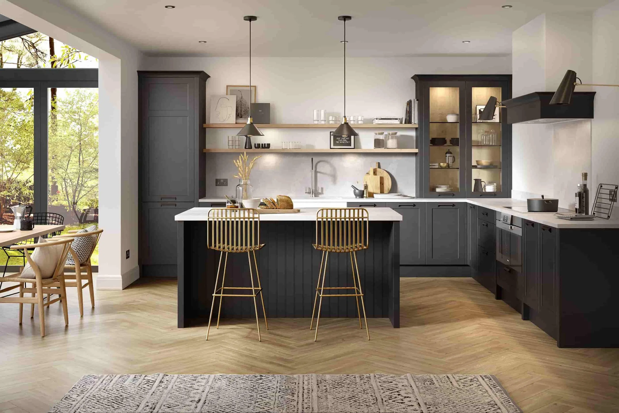 Island kitchen with metal stools, gold faux stools, white walls, white countertop, grey island body, grey cabinets, two pendant lights above the island, wooden laminated floor