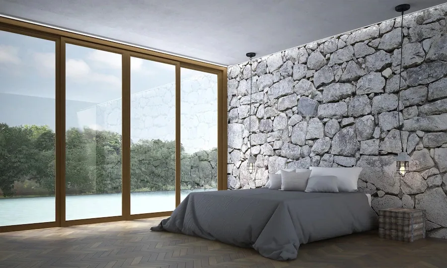 A stone based bedroom wall with outside view